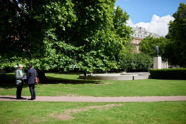 2 people standing in grosvenor square before renovation